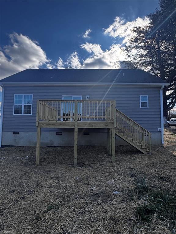 rear view of house featuring a deck