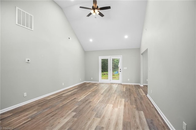 unfurnished living room with light wood-type flooring, high vaulted ceiling, and ceiling fan