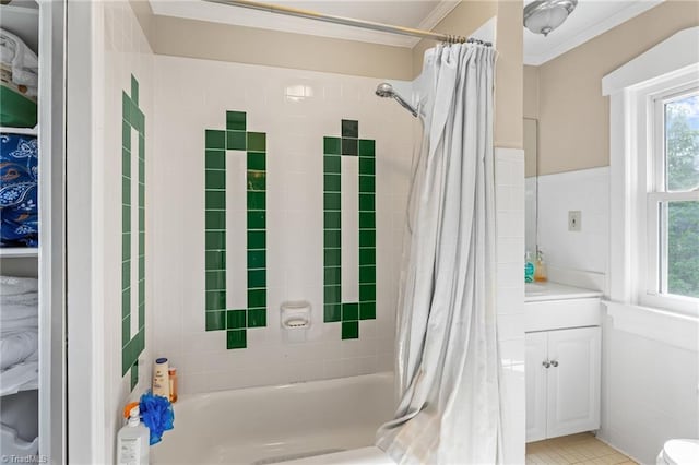 bathroom featuring crown molding, a wealth of natural light, shower / bath combo with shower curtain, and vanity