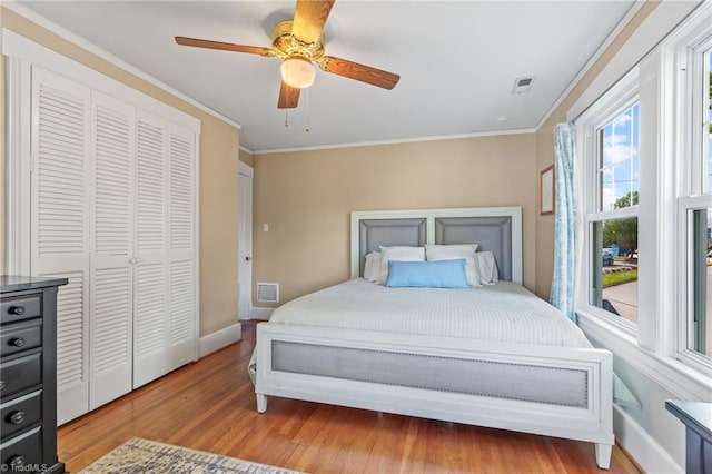 bedroom with crown molding, baseboards, and visible vents