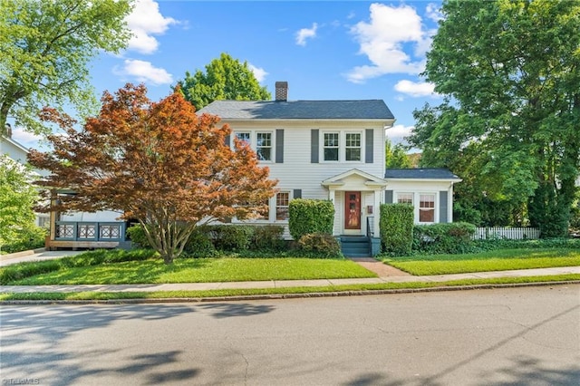 view of front of house featuring fence and a chimney