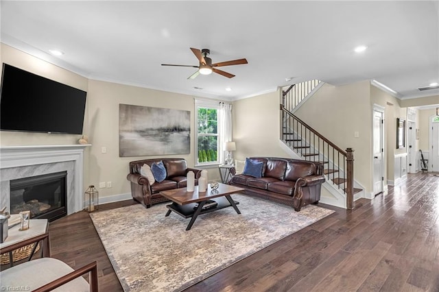 7733 Michaelis St, Greensboro, NC 27455 - living area with ornamental molding, a ceiling fan, baseboards, stairs, and dark wood-type flooring