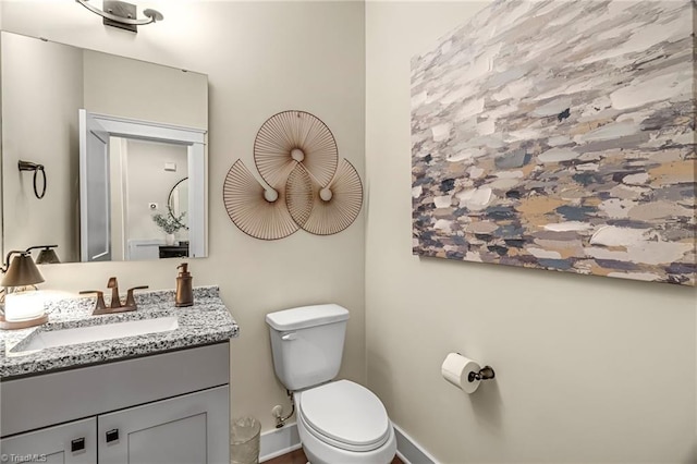 7733 Michaelis St, Greensboro, NC 27455 - bathroom featuring toilet, vanity, and baseboards