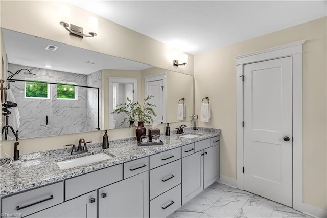 7733 Michaelis St, Greensboro, NC 27455 - full bathroom featuring marble finish flooring, double vanity, a marble finish shower, and baseboards
