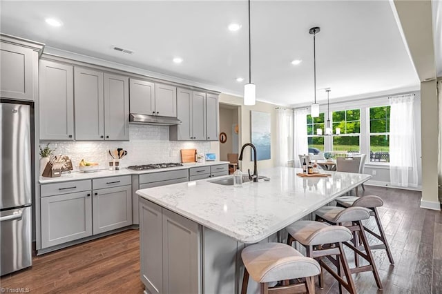 7733 Michaelis St, Greensboro, NC 27455 - kitchen featuring gray cabinetry, stainless steel appliances, a sink, under cabinet range hood, and recessed lighting