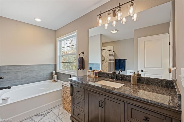 full bath with a shower with curtain, marble finish floor, a garden tub, and vanity