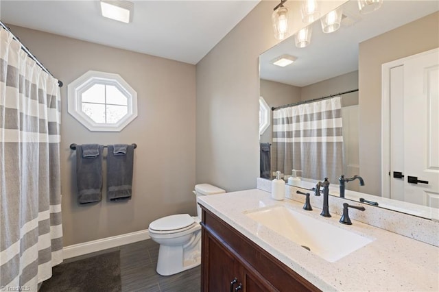 full bath with toilet, a shower with shower curtain, wood finished floors, vanity, and baseboards