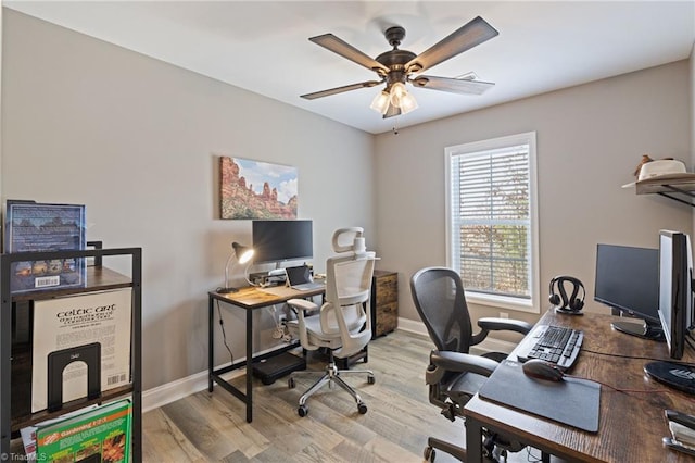 home office with baseboards, a ceiling fan, and wood finished floors