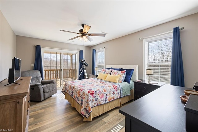 bedroom with access to outside, light wood-style flooring, and a ceiling fan