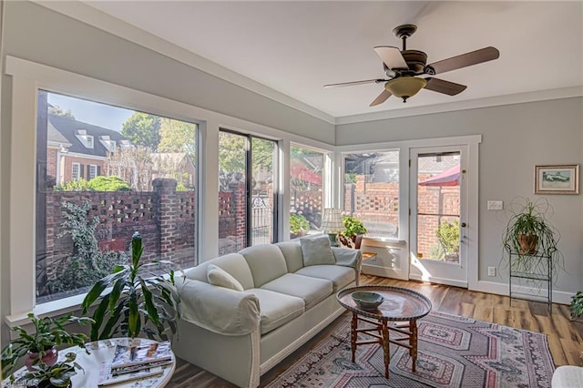 sunroom featuring ceiling fan