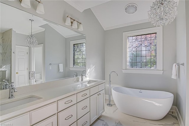 bathroom with a tub, ornamental molding, a wealth of natural light, and vanity