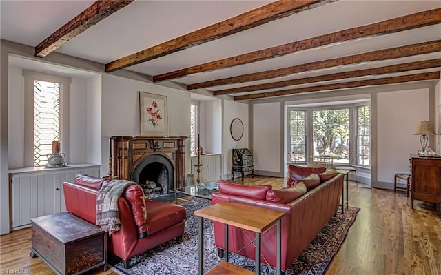 living room featuring beam ceiling and light hardwood / wood-style flooring