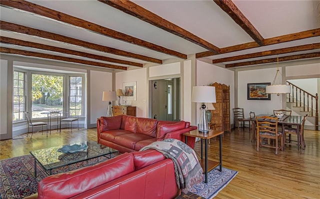 living room featuring light wood-type flooring and beamed ceiling