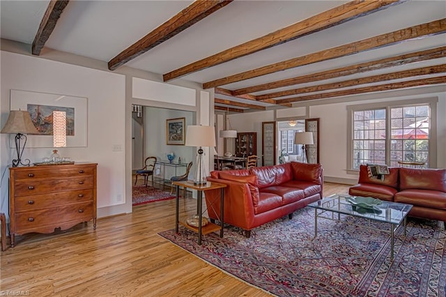 living room featuring light wood-type flooring and beamed ceiling