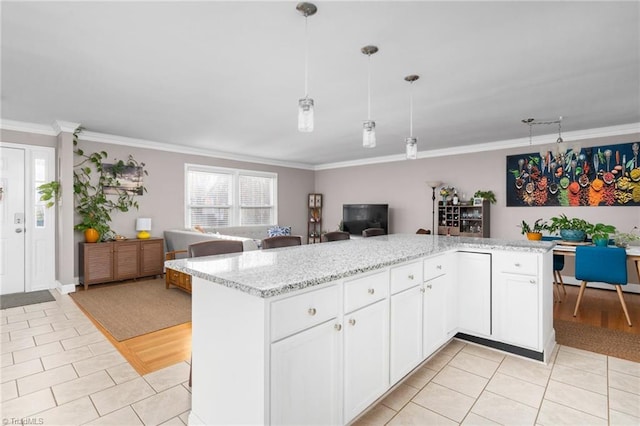 kitchen featuring pendant lighting, white cabinetry, light hardwood / wood-style flooring, and crown molding