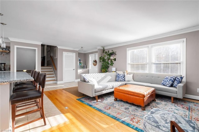 living room with crown molding and light wood-type flooring