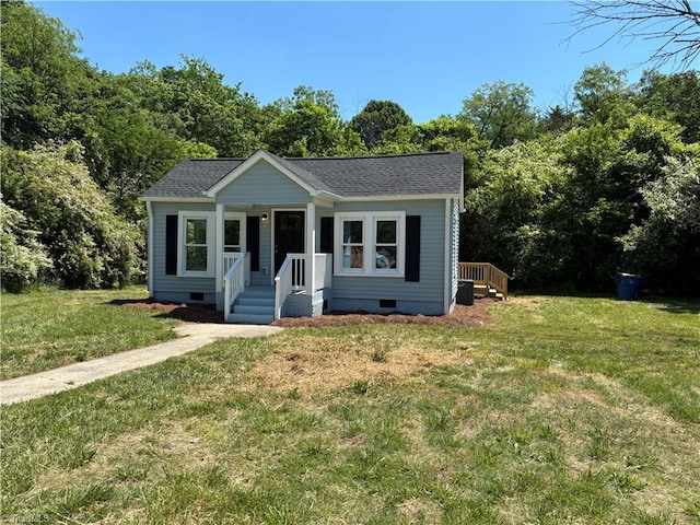 bungalow-style house featuring crawl space, a front yard, and roof with shingles