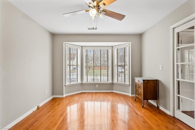 unfurnished room featuring ceiling fan and light hardwood / wood-style floors