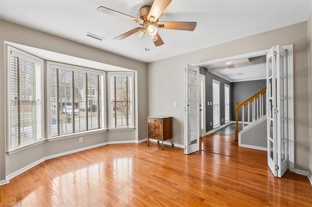 foyer entrance with ceiling fan, french doors, and hardwood / wood-style flooring