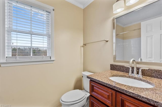 bathroom with vanity, crown molding, a shower, and toilet