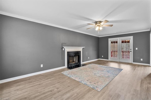 unfurnished living room featuring ornamental molding, ceiling fan, and light hardwood / wood-style flooring