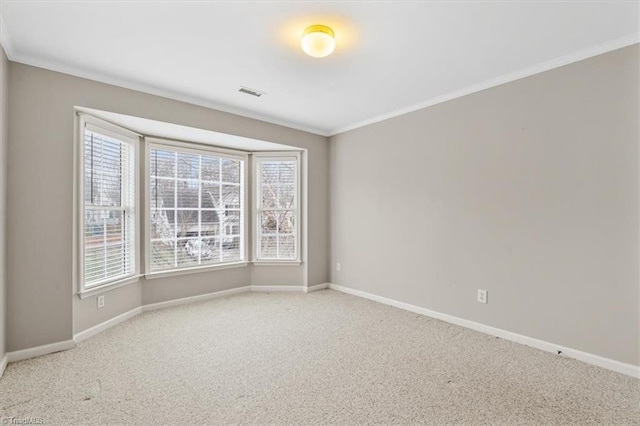 carpeted empty room featuring ornamental molding and plenty of natural light