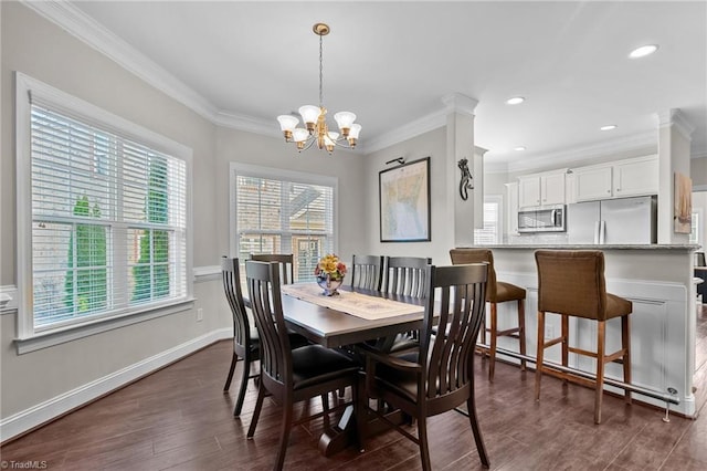 dining room featuring a notable chandelier, crown molding, dark wood-type flooring, and a wealth of natural light