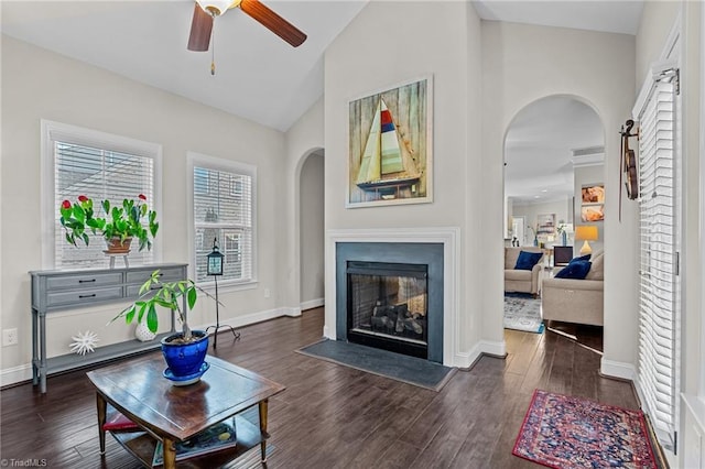 living room with dark hardwood / wood-style floors, ceiling fan, and lofted ceiling