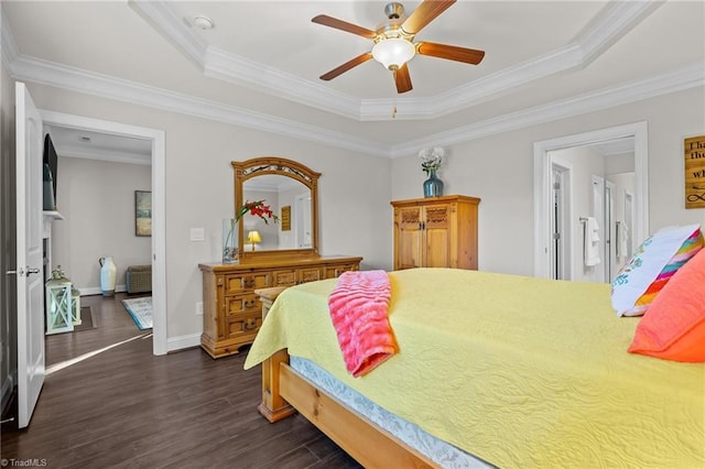 bedroom with ceiling fan, a raised ceiling, ornamental molding, and dark wood-type flooring