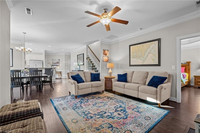 living room featuring ceiling fan with notable chandelier, dark hardwood / wood-style flooring, and crown molding