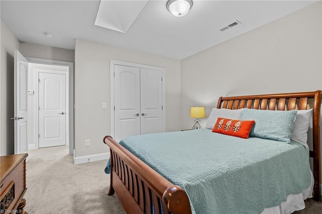 carpeted bedroom with a skylight and a closet