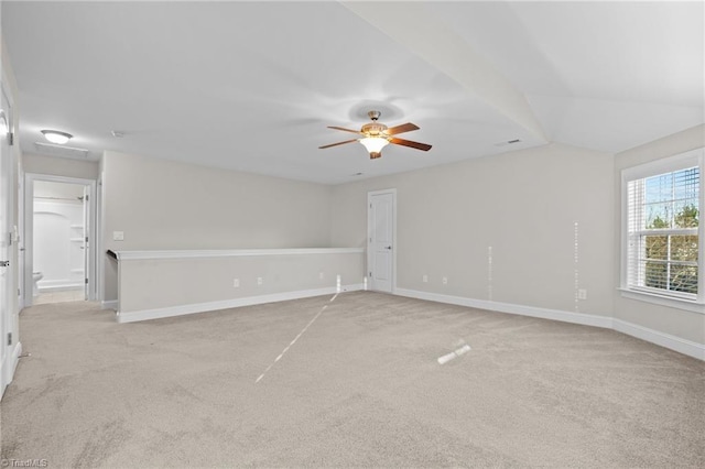 carpeted empty room with ceiling fan and lofted ceiling