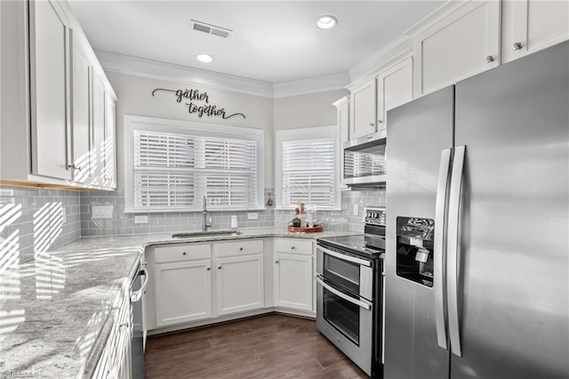 kitchen featuring light stone countertops, appliances with stainless steel finishes, white cabinetry, and sink