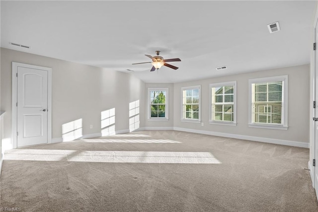 carpeted spare room featuring ceiling fan