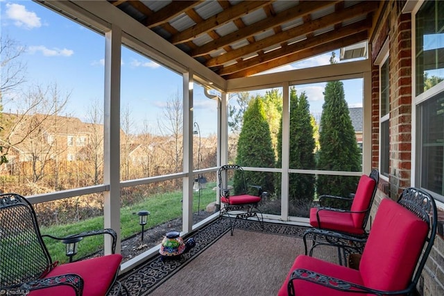 sunroom with a healthy amount of sunlight and vaulted ceiling