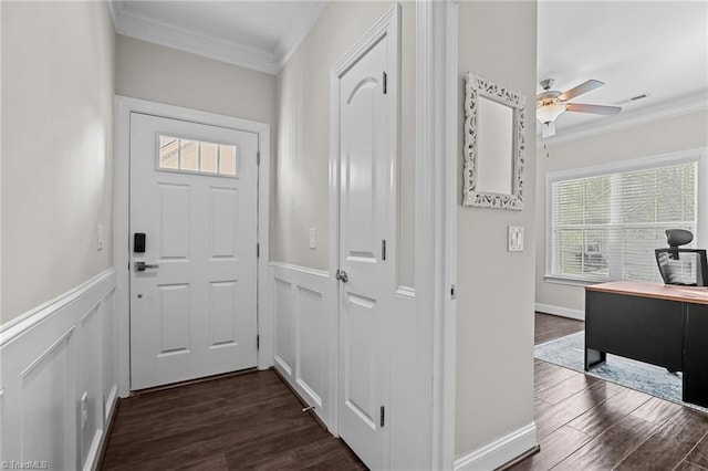 doorway featuring dark hardwood / wood-style flooring, ceiling fan, and crown molding