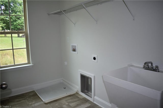 clothes washing area featuring hookup for an electric dryer, sink, and hookup for a washing machine