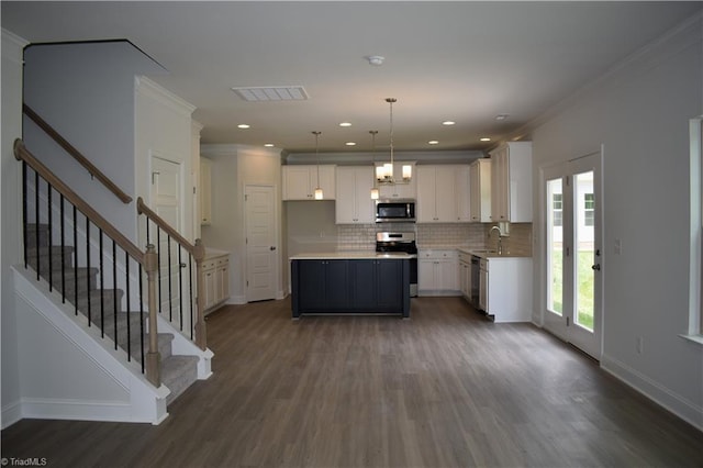 kitchen with white cabinetry, a kitchen island, and stainless steel appliances