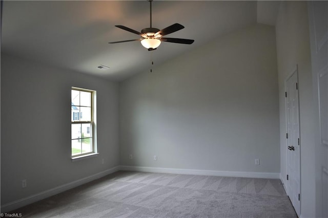 carpeted empty room with ceiling fan and lofted ceiling