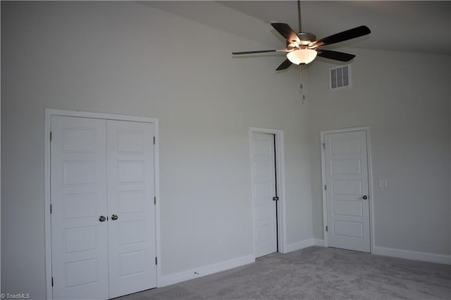 unfurnished bedroom with ceiling fan, light carpet, and high vaulted ceiling