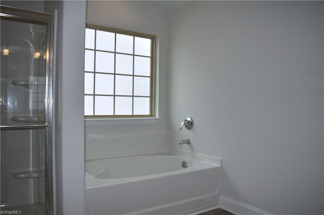 bathroom featuring a bathtub and a wealth of natural light