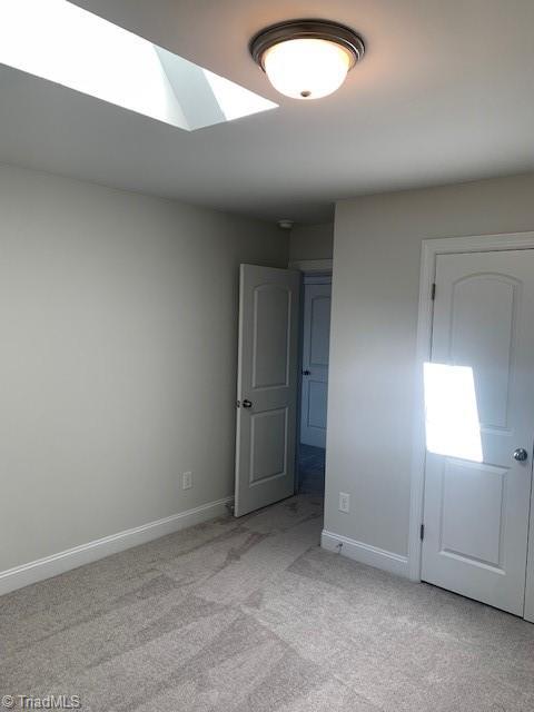 unfurnished bedroom featuring light carpet