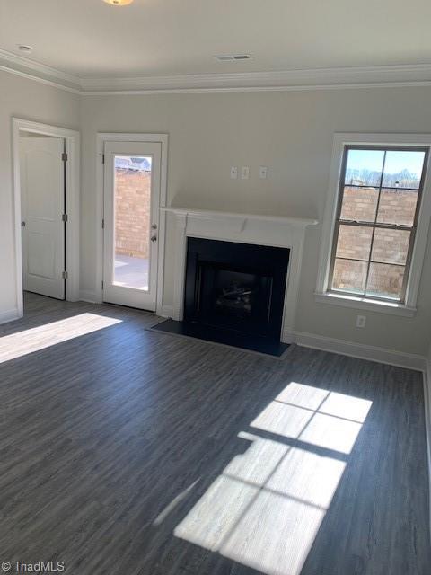 unfurnished living room with dark hardwood / wood-style flooring and crown molding