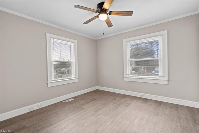 empty room featuring light wood-type flooring, ceiling fan, and ornamental molding