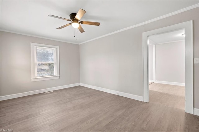 unfurnished room featuring ceiling fan, wood-type flooring, and ornamental molding