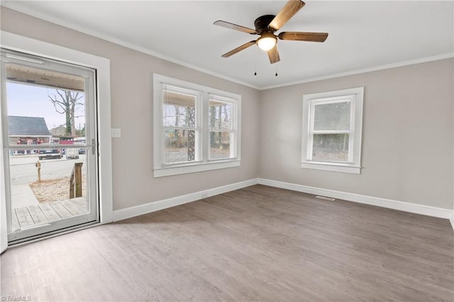 spare room featuring ceiling fan, ornamental molding, and hardwood / wood-style floors