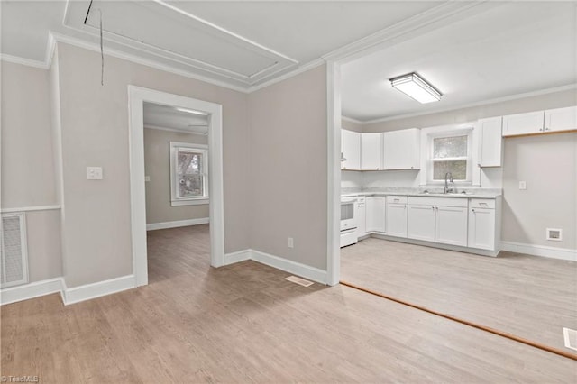 kitchen with white cabinets, range, sink, ornamental molding, and light hardwood / wood-style flooring