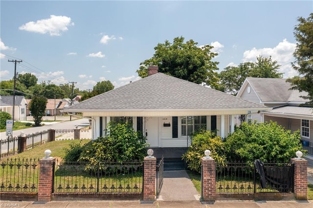 1414 E 3rd St, Winston-Salem, NC 27101 - view of front facade featuring covered porch, a fenced front yard, and roof with shingles