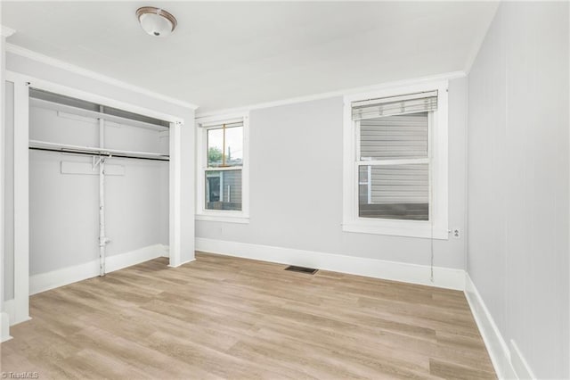 1414 E 3rd St, Winston-Salem, NC 27101 - unfurnished bedroom featuring ornamental molding, light wood-style floors, and a closet