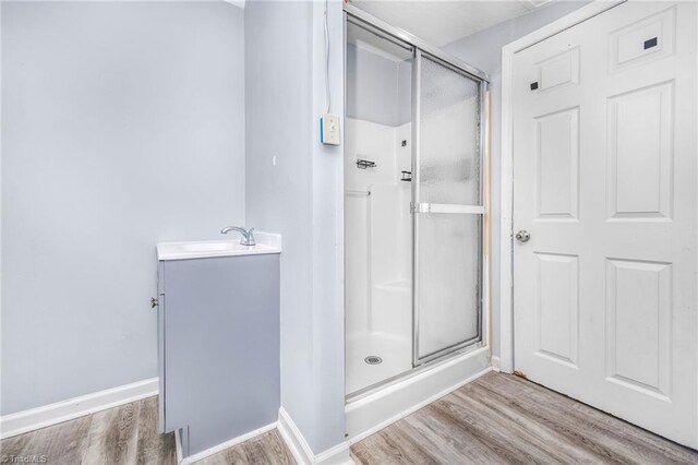 1414 E 3rd St, Winston-Salem, NC 27101 - bathroom featuring wood finished floors, a stall shower, and vanity
